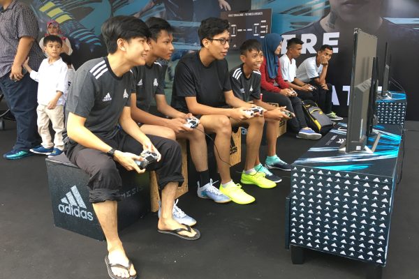 Pick up a controller and play a "friend" for a match of football on the screen.